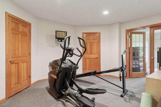 The second lower-level flex room is currently configured as an exercise space but offers versatile potential to serve as a home office, hobby room, or media area-adaptable to fit your unique needs.