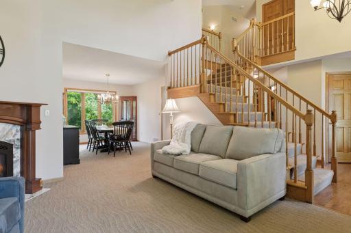 Adjacent to the dining room, the living room features soaring two-story ceilings.