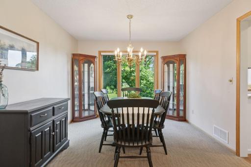 The formal dining room extends the kitchen space and offers beautiful views of the backyard.