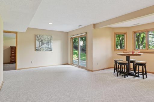 The lower-level sliding door opens to an expansive private patio, perfect for outdoor entertaining and relaxation, with tranquil views of the lush backyard and the picturesque Prestwick Golf Course beyond.