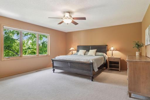 Enjoy beautiful vistas of the backyard and course from the spacious primary suite.