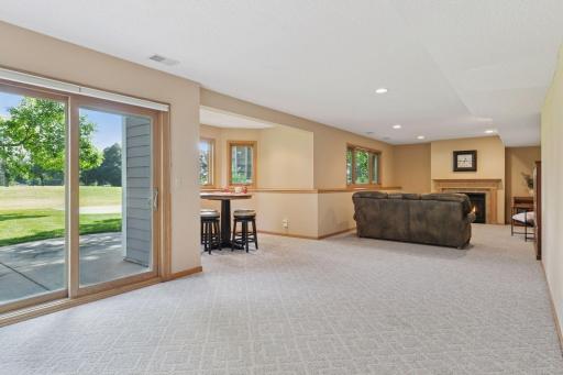 The walkout lower level features a spacious recreation room, game area, future wet bar, and two versatile flex spaces-one easily convertible into a sixth bedroom. It also includes a remodeled 3/4 bathroom complete with luxurious in-floor heating.