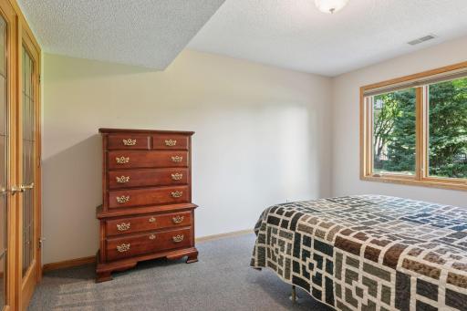The lower-level flex room offers versatile space that can easily be transformed into a comfortable sixth bedroom, guest suite. or home office-providing flexibility to suit your lifestyle and needs.