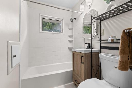 Updated bathroom featuring new vanity, toilet, and Bathfitters tub with lifetime warranty