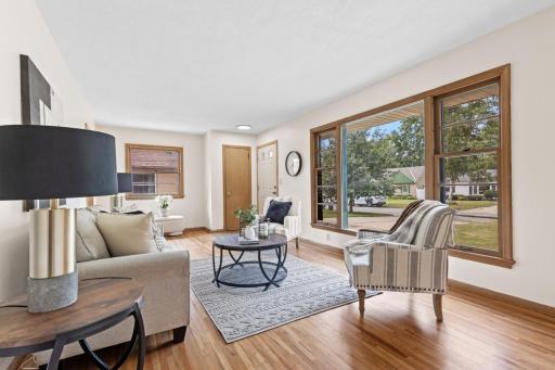 Bright, sun-filled living room with classic hardwood floors