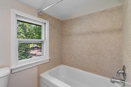 The upper level features a bathroom with a full tub.