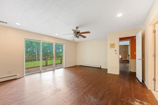 Huge primary suite with private deck and view of the yard and pool.