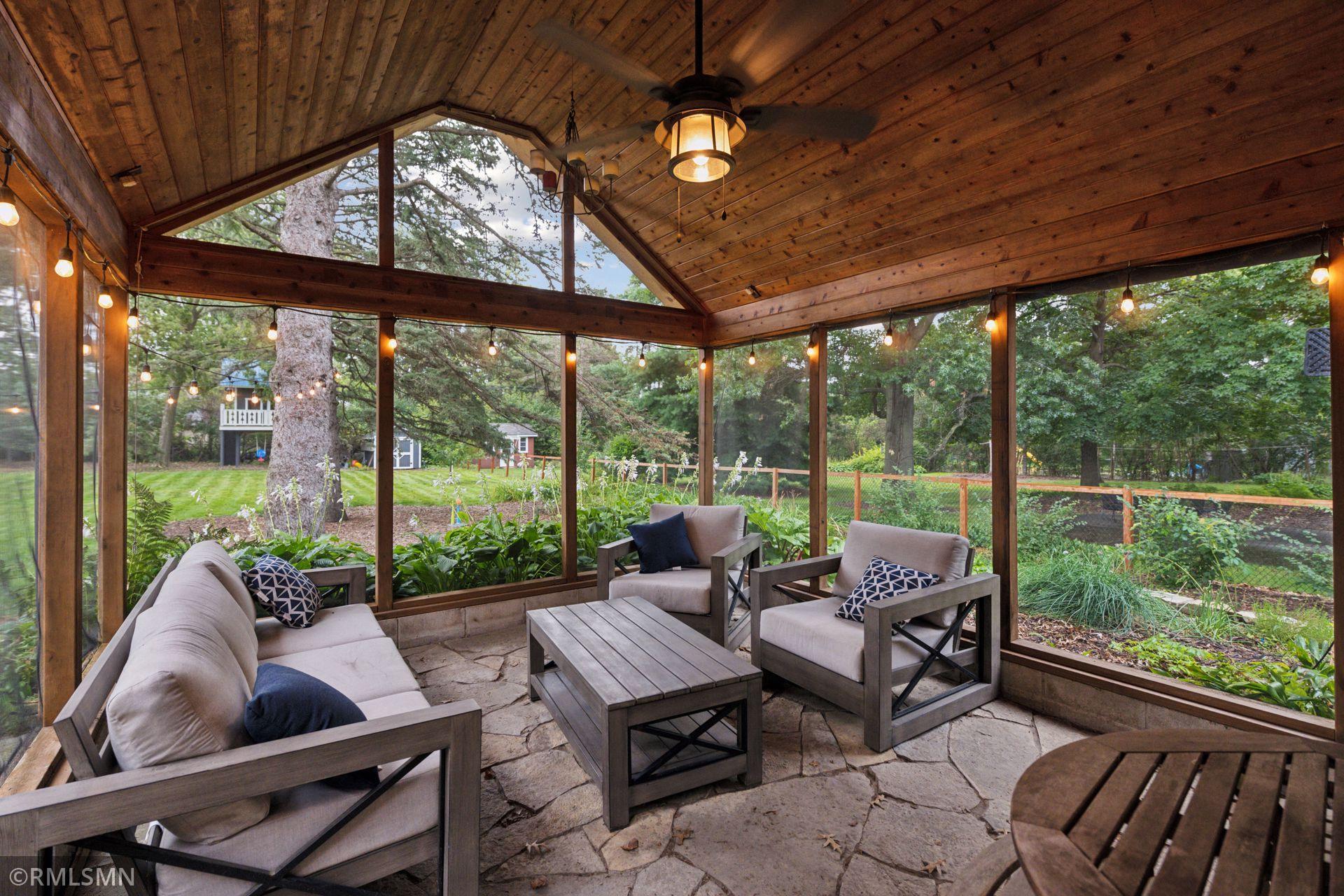 Flagstone patio leads to spacious 3-season screen porch