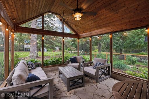 Flagstone patio leads to spacious 3-season screen porch