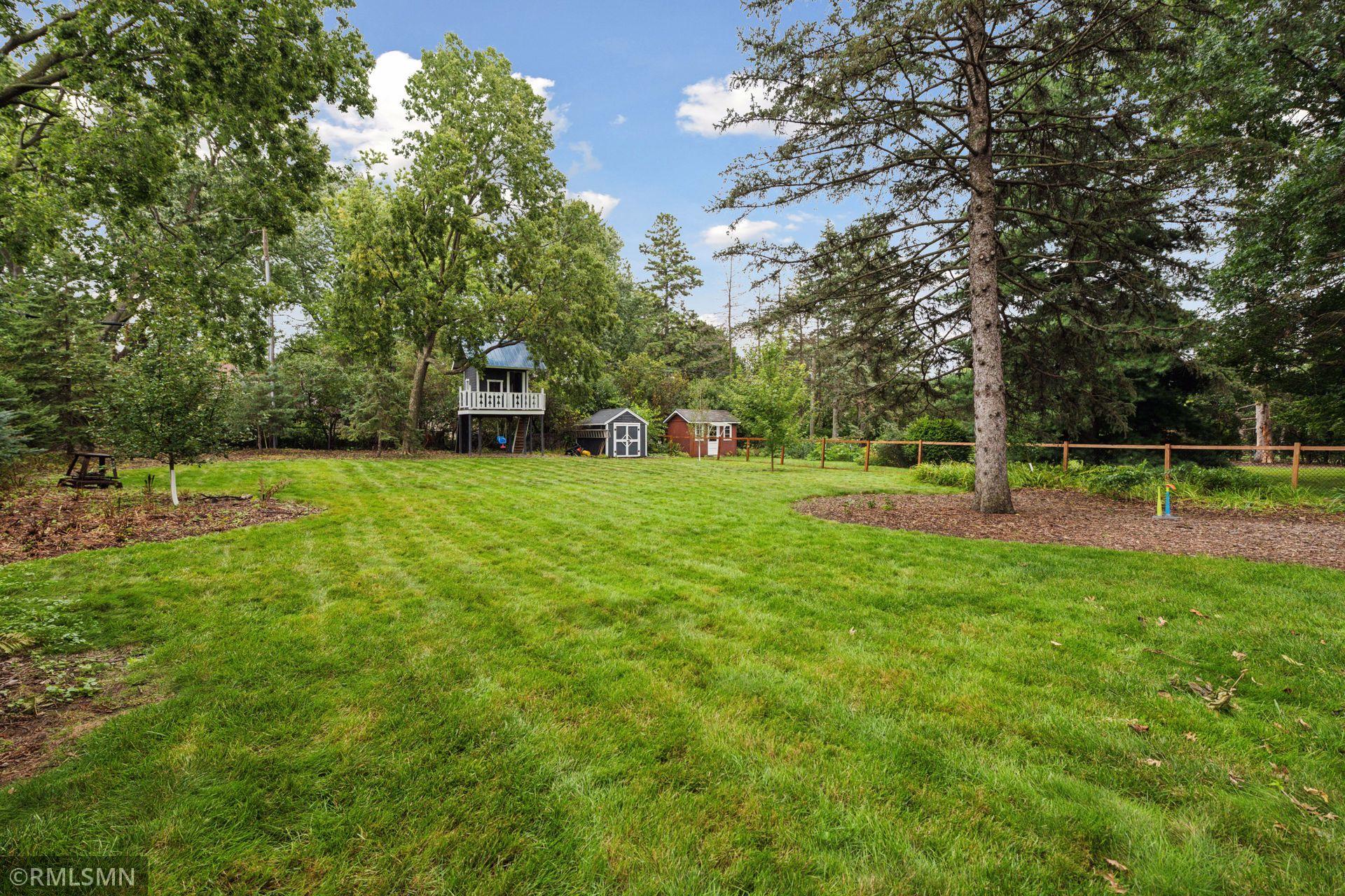 Gorgeous flat backyard. Storage shed and your own treehouse!