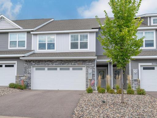 Charming end-unit townhome with modern curb appeal in the High Pointe community.