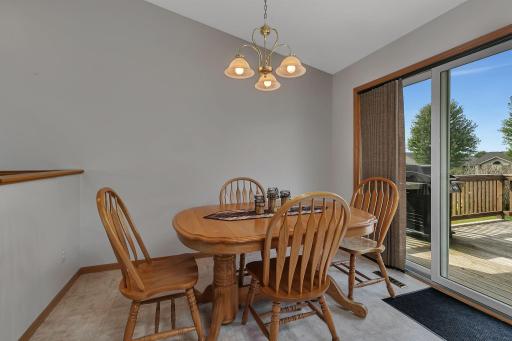 Enjoy meals in this cozy dining nook, featuring a classic chandelier and easy access to the deck through sliding glass doorsâperfect for indoor-outdoor living and entertaining.