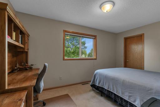 Bright second bedroom with versatile layoutâideal for a guest room, home office, or study space. Large window provides backyard views and natural light.