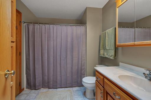 Full bathroom with a clean, functional layout featuring a large vanity, ample cabinet storage, and a shower/tub comboâperfect for daily convenience.