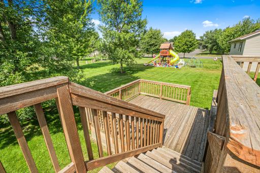 Deck stairs lead directly to the spacious yard, with plenty of room for playsets, gardens, or outdoor fun.