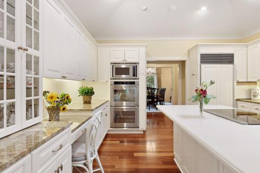 The kitchen opens to the formal dining room and to the living room and family room, offering perfect flow for entertaining