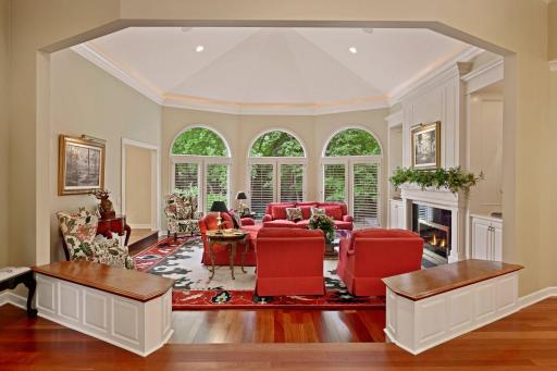 The formal living room is dramatic! Owners had it remodeled by Tom Potter to include oversize custom millwork with indirect lighting, custom new paneled fireplace facade and surround, new built in art nooks & new half paneled knee wall w cherry top