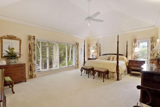 The expansive primary suite is a true retreat with wonderful sunlight and treetop views to the private backyard and fountain, vaulted ceiling and wood floors under the current carpet