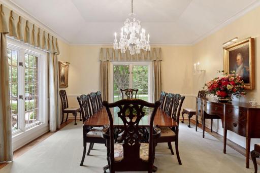 The formal dining room is elegant and lovely with Baccarat French crystal chandelier and sconces