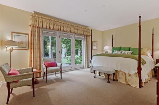 The 3rd bedroom is a truly stunning suite that is large and opens to a perfect patio nook for morning coffee and the sounds and views of the private back yard with pond and fountain -
