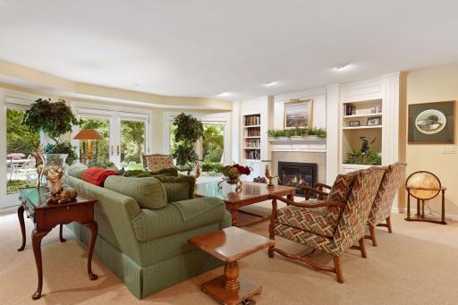 High ceilings and a third gas fireplace with french doors leading to the paver patio