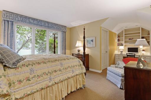 The 4th bedroom is cozy with desk and built ins and large walk in closet