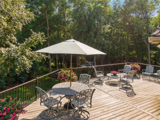 This cedar deck is a highlight for the current owners who designed it to be a true outdoor living space. It is large and offers multiple seating areas, stunning views of the professionally landscaped gardens and a built in grilling station
