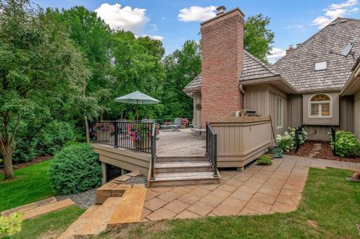 Owners added the new cedar deck, grilling station with granite counter, and the added stone steps to lower level yard and patio.