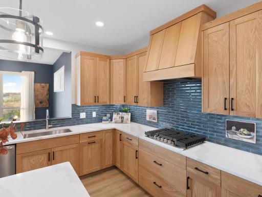 Quartz countertops throughout this home, hood does vent outside