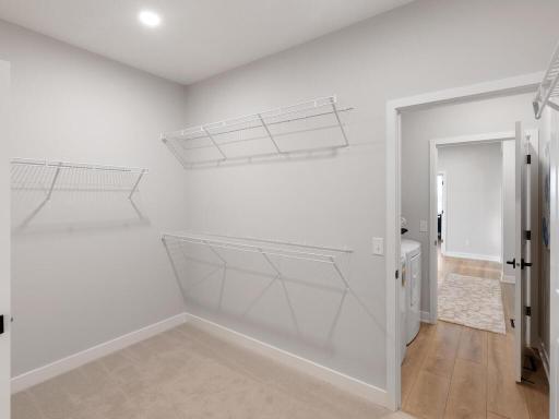Walk in closet with laundry room pass through