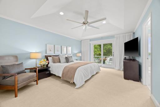 Primary with a private balcony, ceiling fan and sumptuous wool carpeting