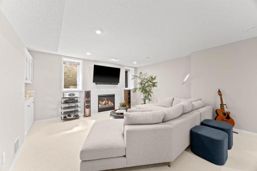 Spacious recreation room with gas fireplace & freshly painted spaces
