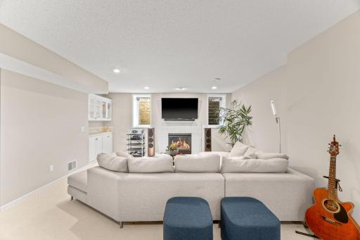 Cozy up to the fireplace and enjoy a movie. Built in cabinetry for your coffee/wine bar.