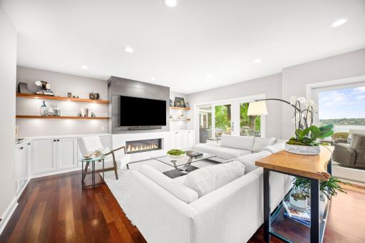 Floating shelves adorn the modern gas fireplace