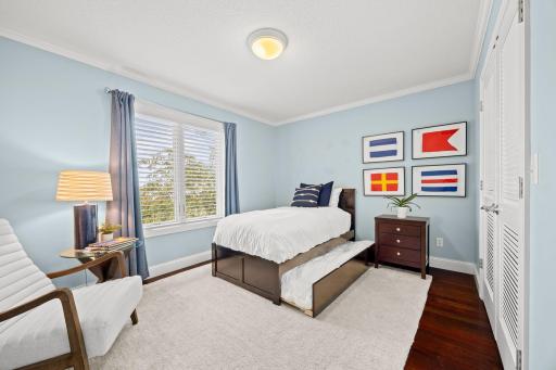 Bedroom 2 upper level with hardwood floors and large custom closet organizer