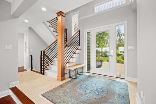Welcoming foyer with travertine and new Renewal by Anderson front door package
