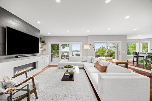 Sun filled living room that spills onto the large deck with expansive lake views