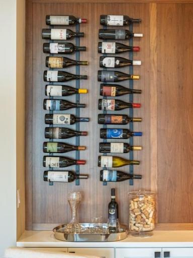 A walnut adorned wall creates design interest for the wine display