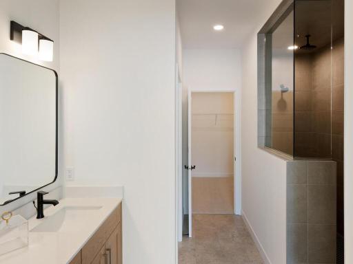 Walk-in shower and closet in this primary suite