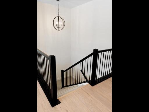 Wide staircase leading to finished lower level is well lit by tread lights