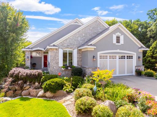 Beautiful stone accented exterior w/ lush landscaping & welcoming curb appeal