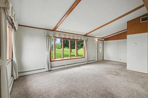 Another view of the living room. The large windows fill the room with natural light.