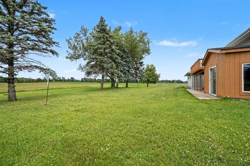 The backyard also includes a large concrete patio that extends from the sunroom to the garage with a large portion covered by the deck.