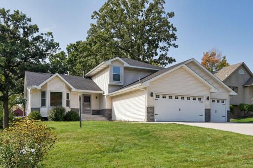 Gorgeous home seated on a large, lush front lawn.