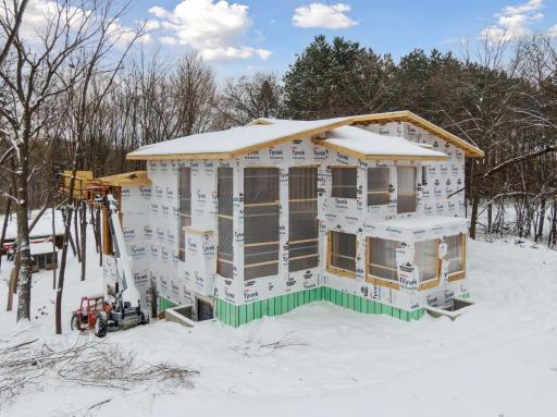 Nestled among mature trees, this custom home blends modern design with a private, nature-immersed setting.