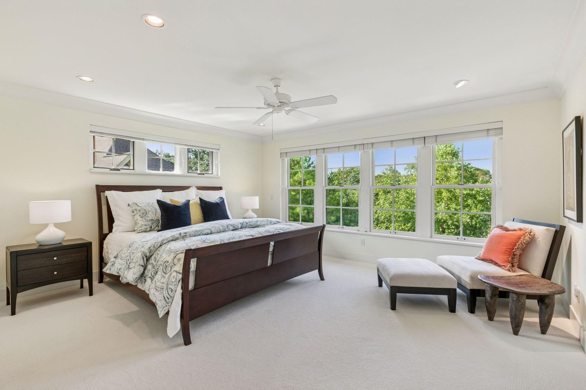 Expansive owner's suite has a wall of windows providing long treetop views.