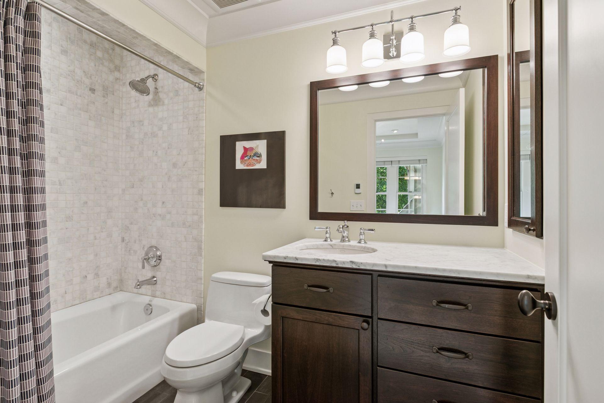 Full bathroom upstairs with custom 36" vanity, marble countertop and tub surround with heated porcelain floors.
