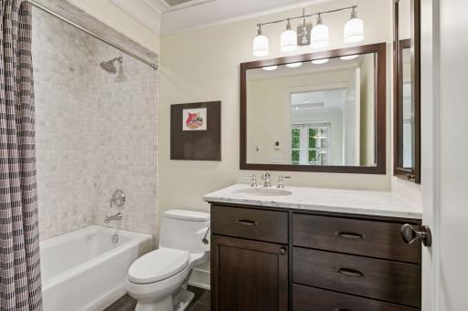 Full bathroom upstairs with custom 36" vanity, marble countertop and tub surround with heated porcelain floors.