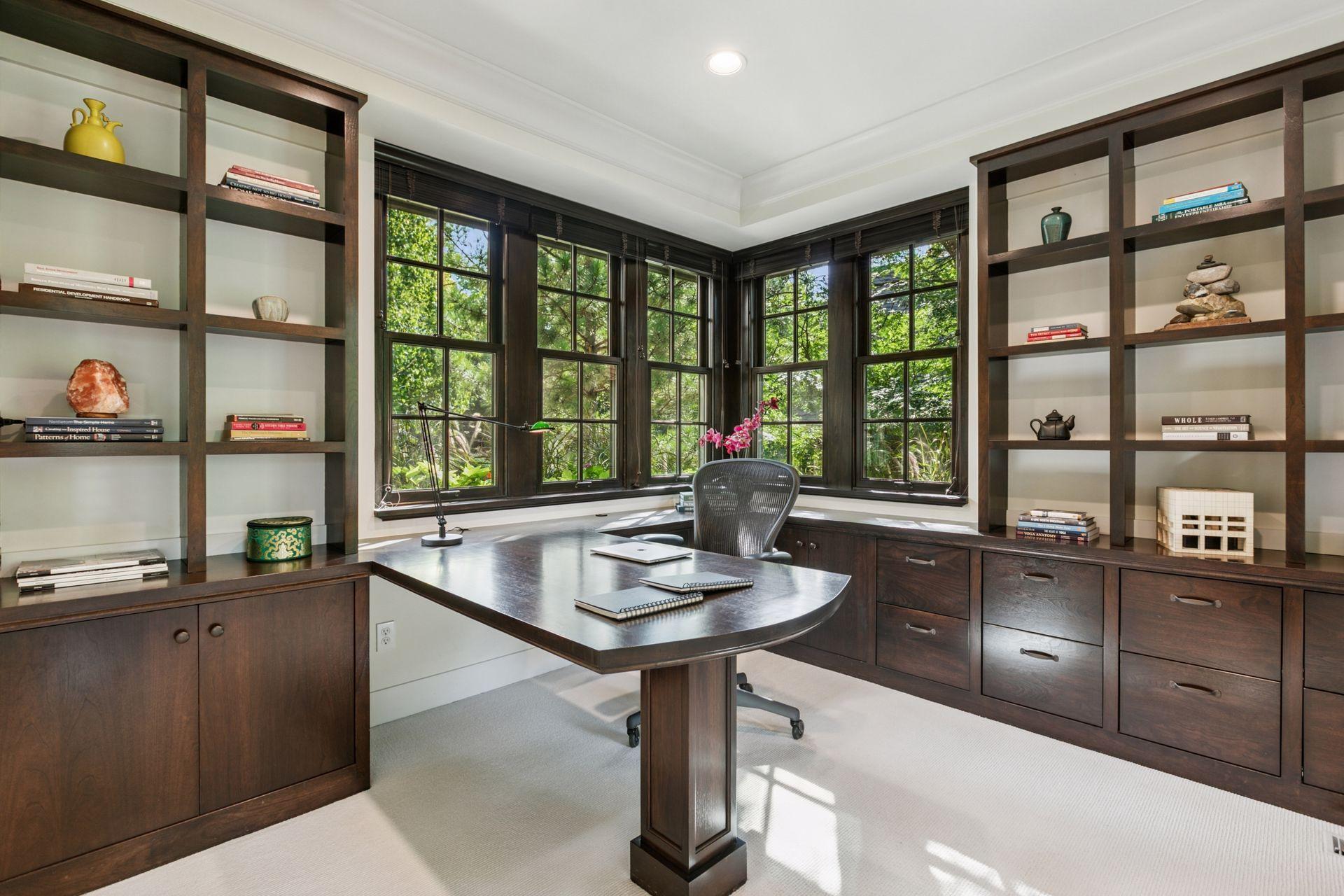 Executive office with amazing views from every angle! Enjoy a built-in desk, built-in locking file cabinets, drawers and shelving.