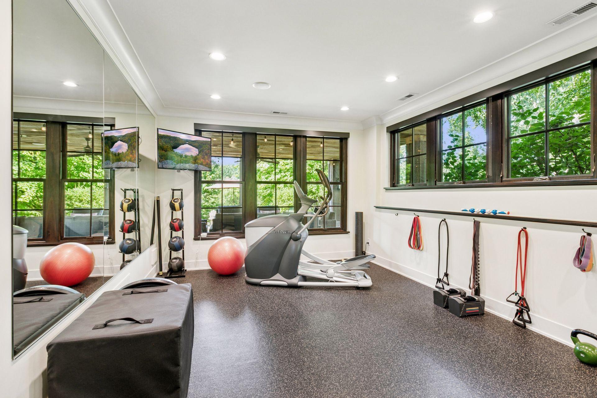 Soundproof gym with rubber flooring and mirrored wall is also a legal 5th bedroom.